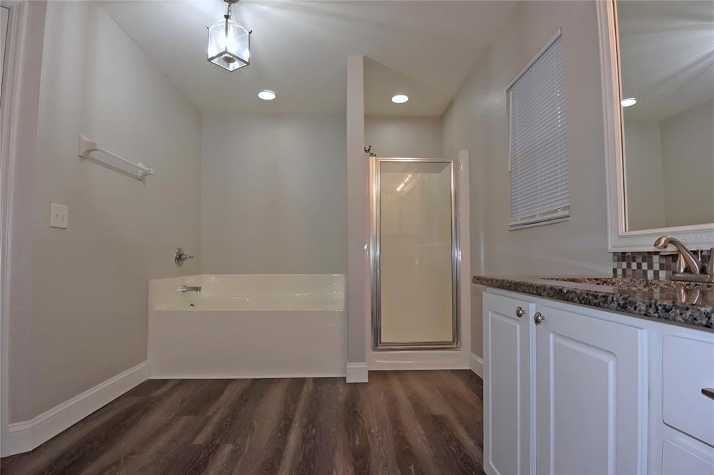 12042 Linden Drive Spring Hill, FL 34608 - Photo 25 of 41 a bathroom with a sink a toilet and shower