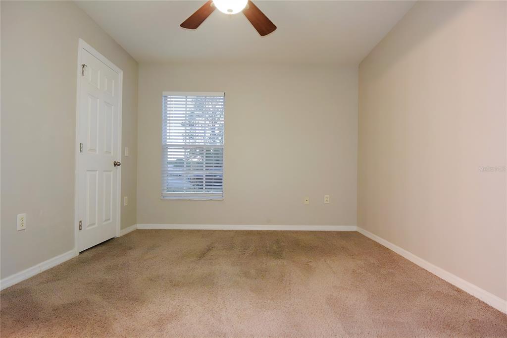 12042 Linden Drive Spring Hill, FL 34608 - Photo 28 of 41 an empty room with chandelier fan