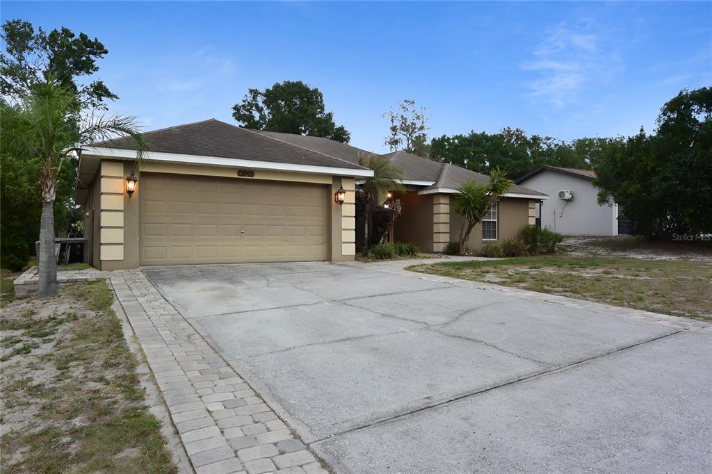 12042 Linden Drive Spring Hill, FL 34608 - Photo 37 of 41 a front view of a house with a yard and garage