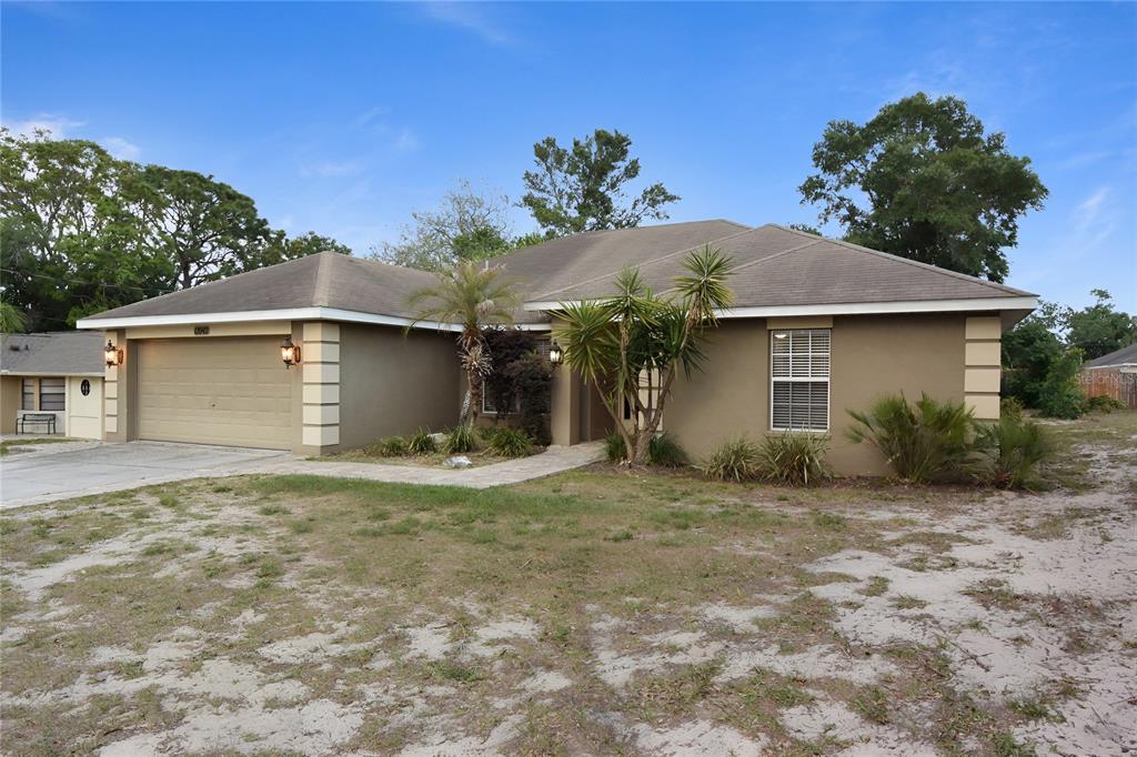 12042 Linden Drive Spring Hill, FL 34608 - Photo 39 of 41 a view of a house with a yard and garage