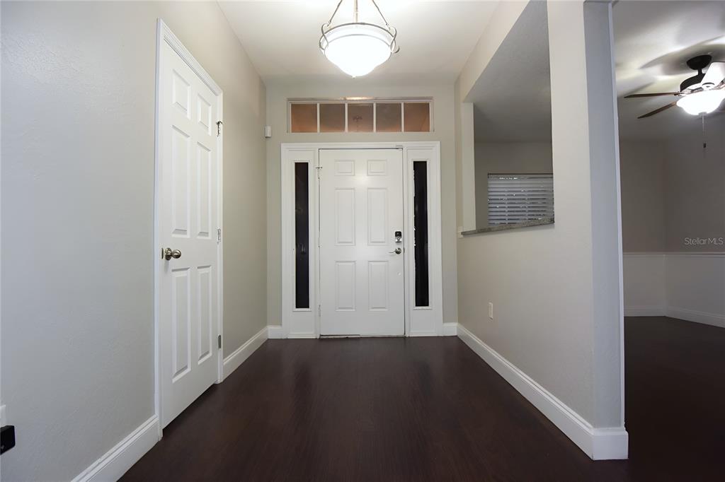 12042 Linden Drive Spring Hill, FL 34608 - Photo 4 of 41 an entryway to room with wooden floor
