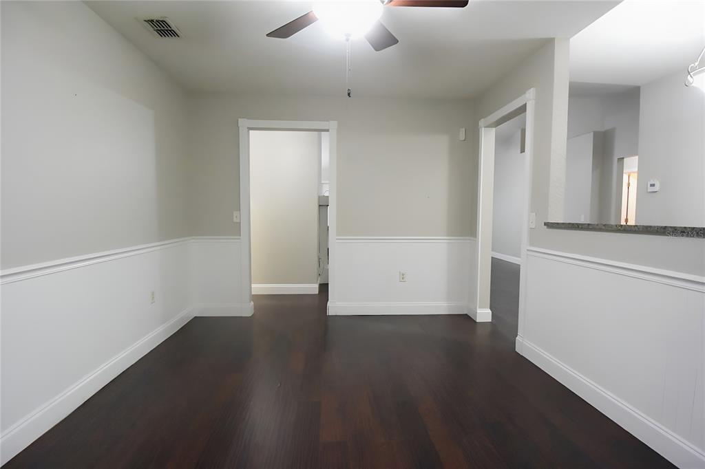 12042 Linden Drive Spring Hill, FL 34608 - Photo 8 of 41 an empty room with wooden floor and door