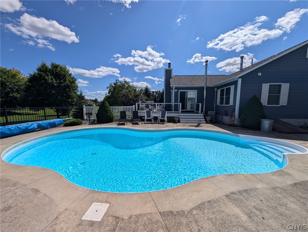 1322 Sawmill Road Sangerfield, NY 13480 - Photo 7 of 50 A sparkling in-ground pool anchors the backyard space alongside a spacious concrete patio.