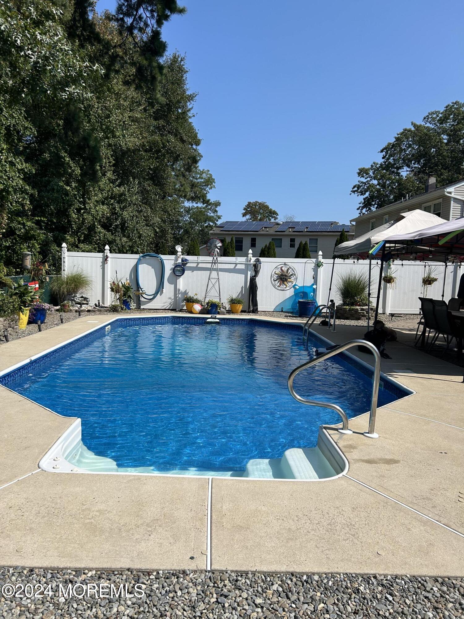 136 Smith Circle Point Pleasant, NJ 08742 - Photo 14 of 35 a view of a swimming pool with lounge chairs