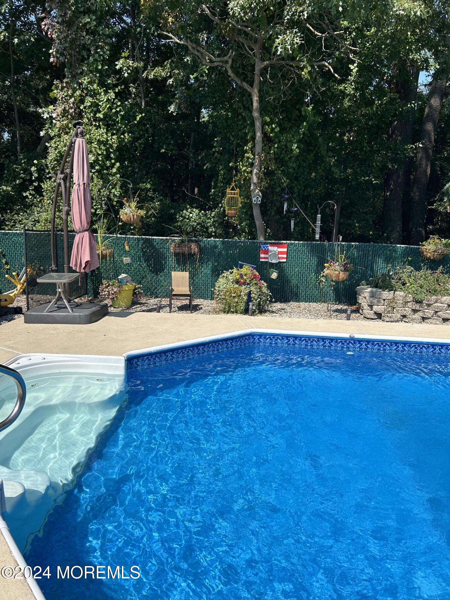 136 Smith Circle Point Pleasant, NJ 08742 - Photo 17 of 35 a view of a lake with a bench and trees