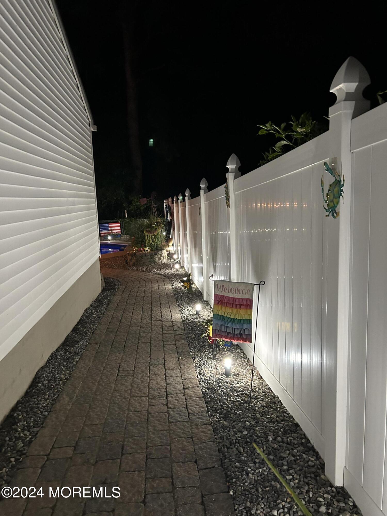 136 Smith Circle Point Pleasant, NJ 08742 - Photo 22 of 35 a view of a patio with table and chairs with wooden floor