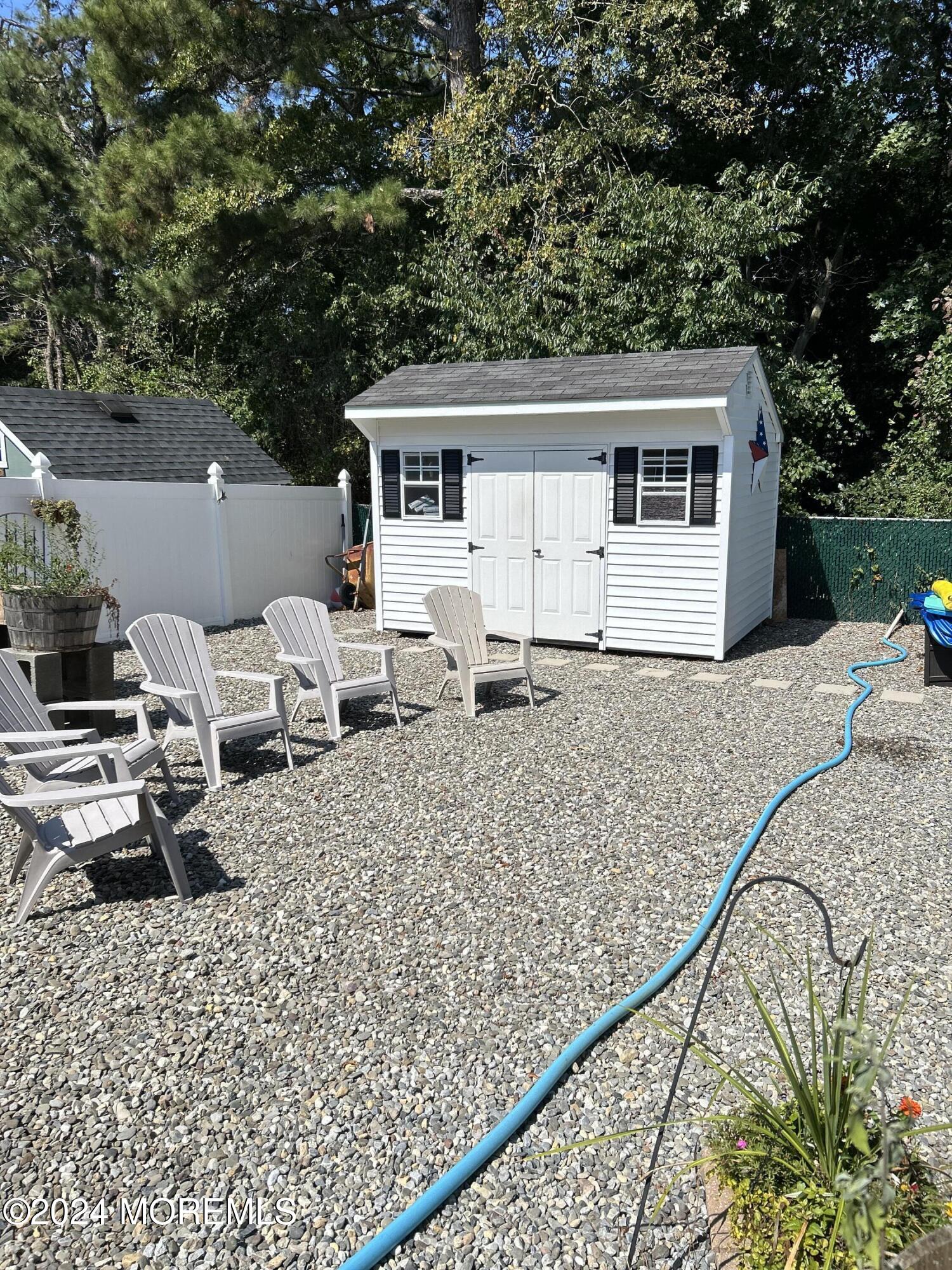 136 Smith Circle Point Pleasant, NJ 08742 - Photo 23 of 35 a view of house with backyard and seating area