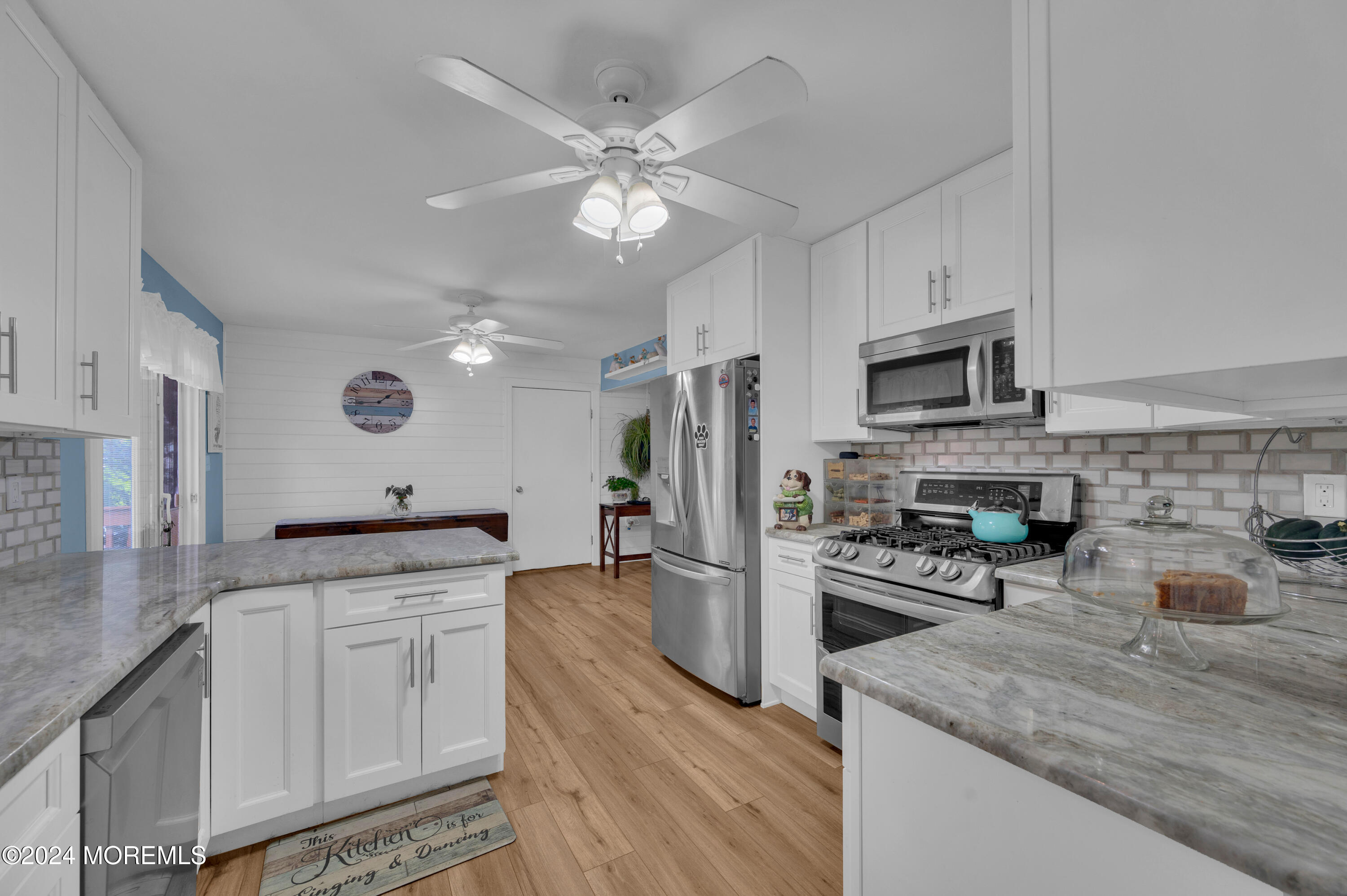 136 Smith Circle Point Pleasant, NJ 08742 - Photo 7 of 35 a kitchen with granite countertop a sink stainless steel appliances and white cabinets