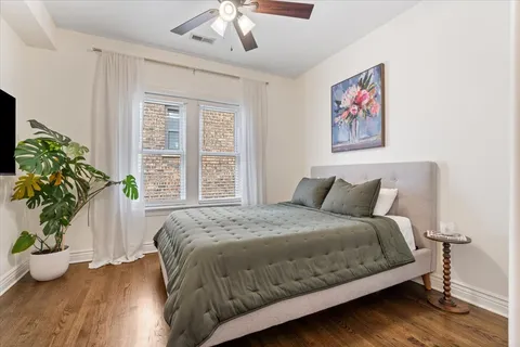 a bedroom with bed and a potted plant