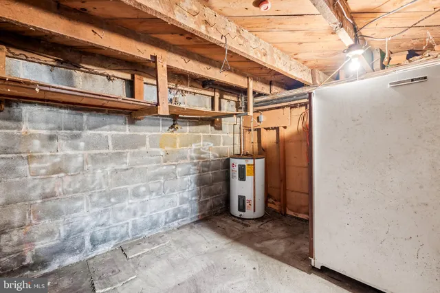 an empty room with wooden floor and cabinet