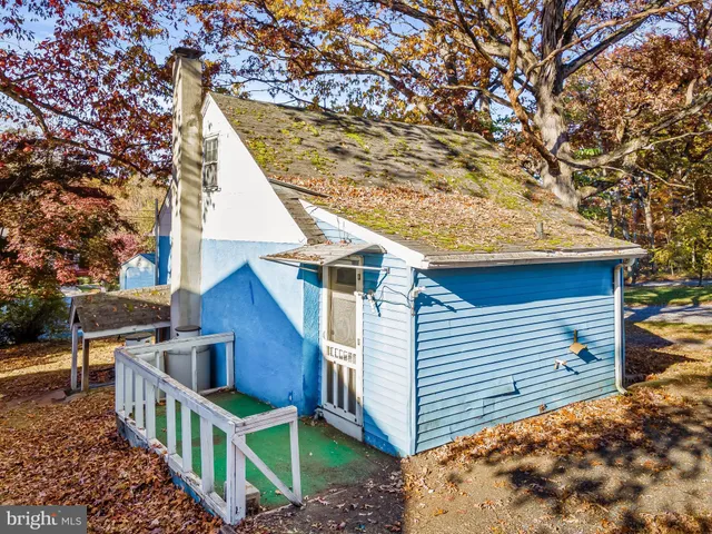 a view of a house with wooden fence