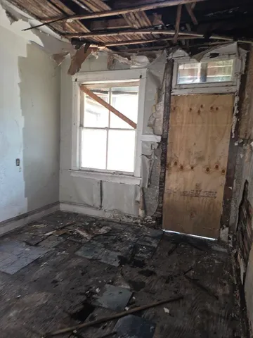 a view of a room with a wooden door