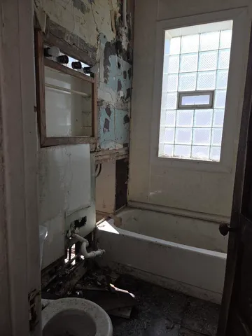 a bathroom with a bathtub and shower