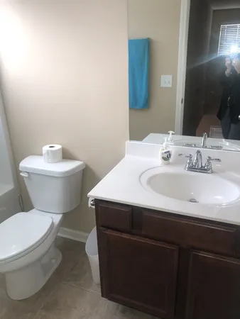 a bathroom with a sink toilet and a mirror