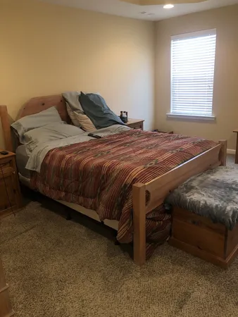 a bedroom with a bed and a window