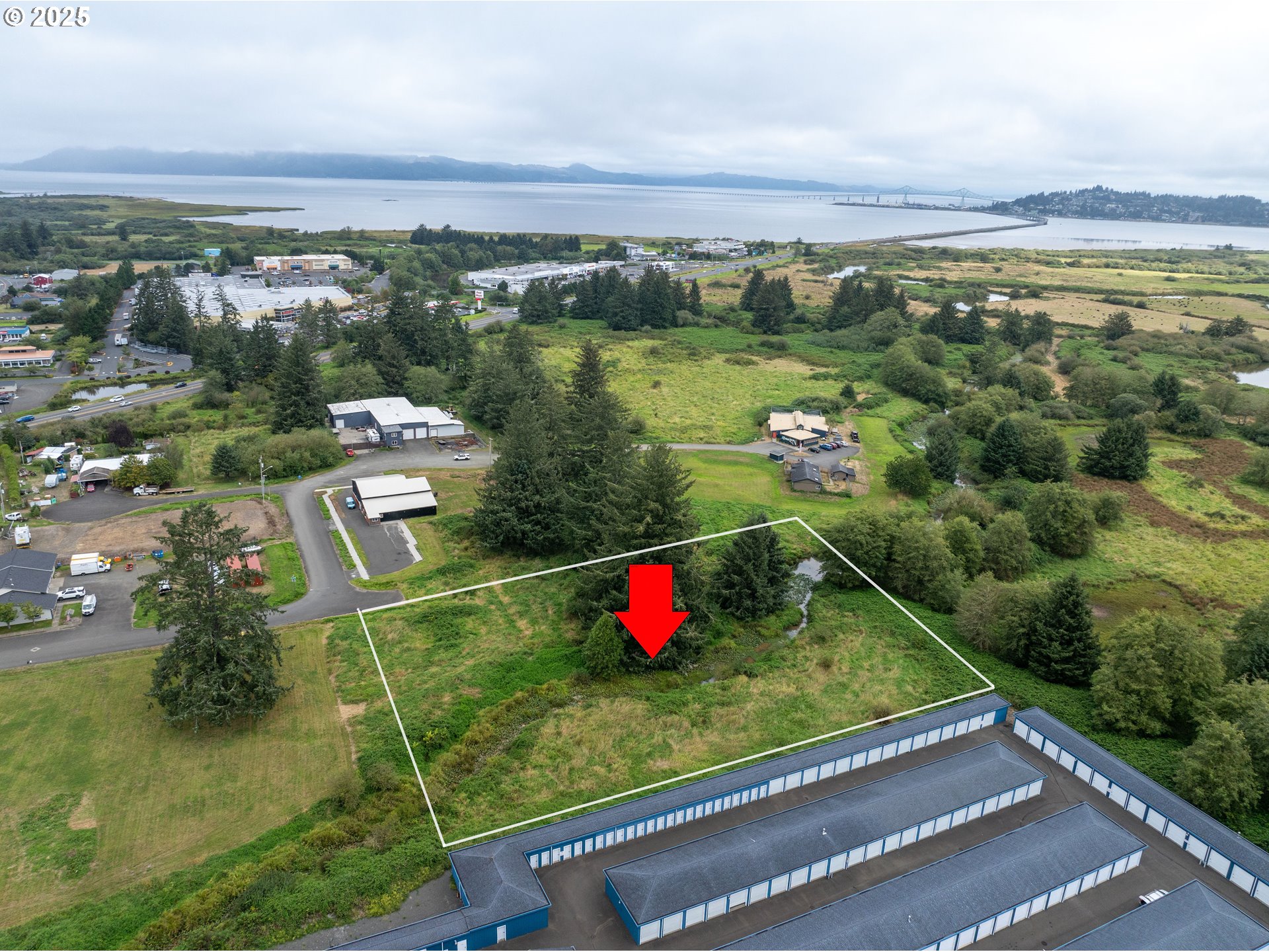 an aerial view of residential houses with outdoor space and river