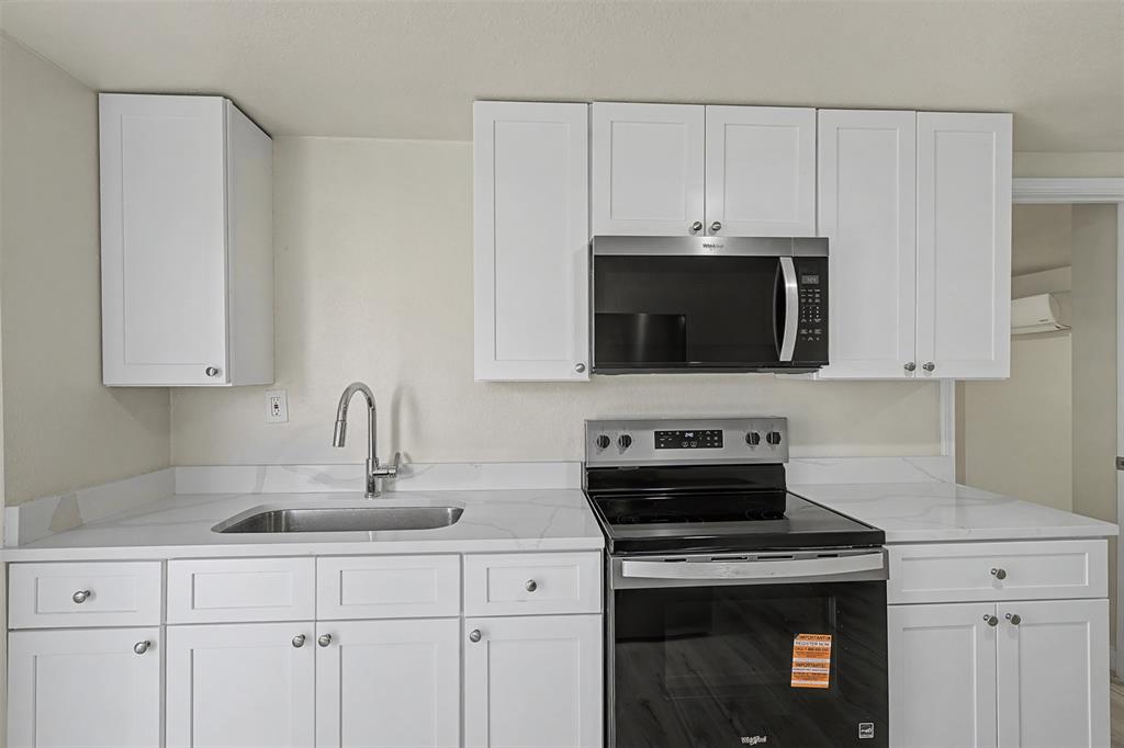 9021 White Settlement Road White Settlement, TX 76108 - Photo 18 of 33 a kitchen with stainless steel appliances a stove a sink a stove and cabinets