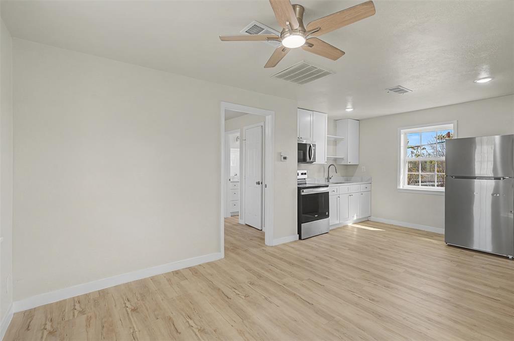 9021 White Settlement Road White Settlement, TX 76108 - Photo 22 of 33 a view of a kitchen with wooden floor electronic appliances and window