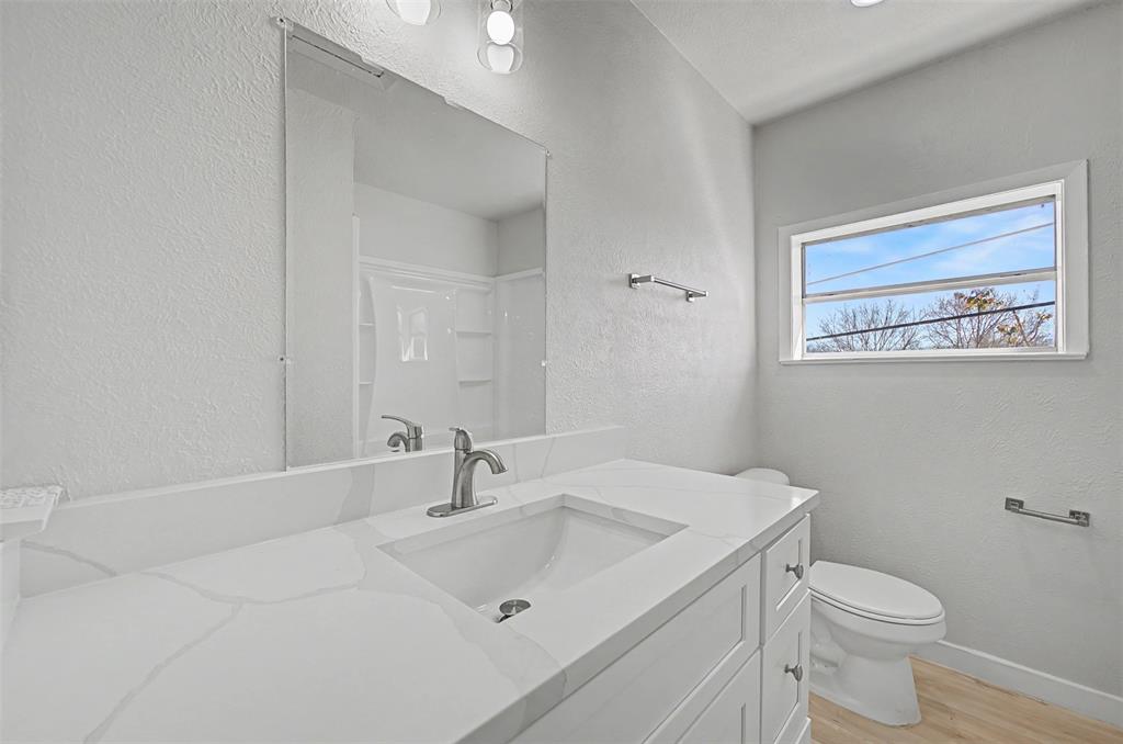 9021 White Settlement Road White Settlement, TX 76108 - Photo 23 of 33 a bathroom with a sink a toilet and mirror