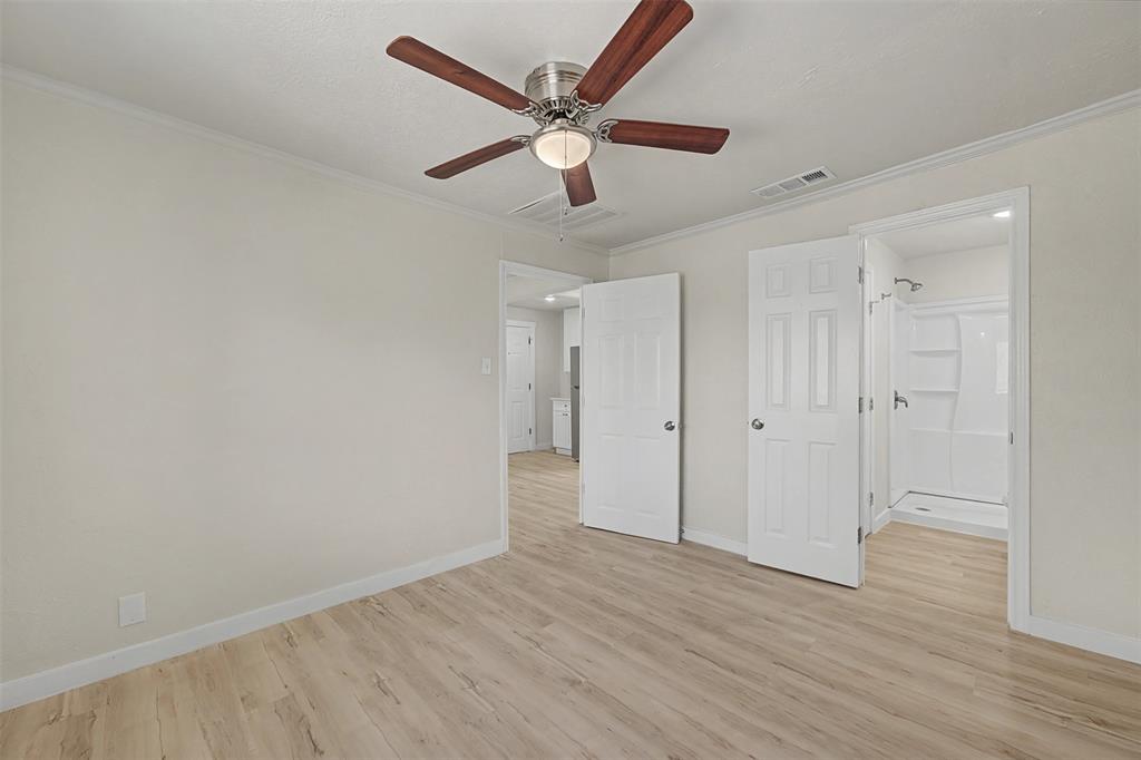 9021 White Settlement Road White Settlement, TX 76108 - Photo 24 of 33 an empty room with wooden floor and ceiling fan