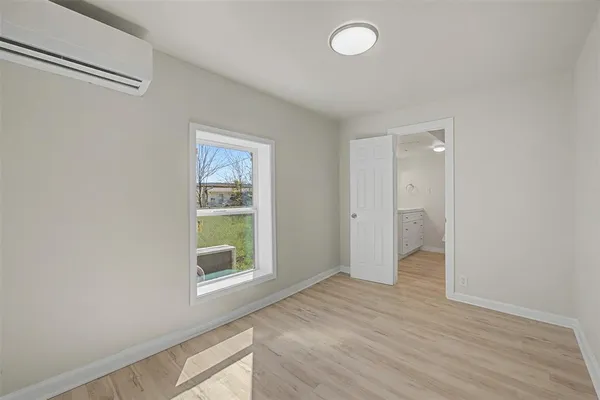 a spacious bathroom with a toilet sink and mirror
