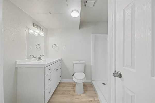 a kitchen with a refrigerator and a stove top oven