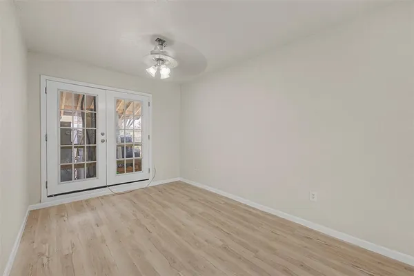 a kitchen with stainless steel appliances a sink dishwasher stove and microwave with wooden floor