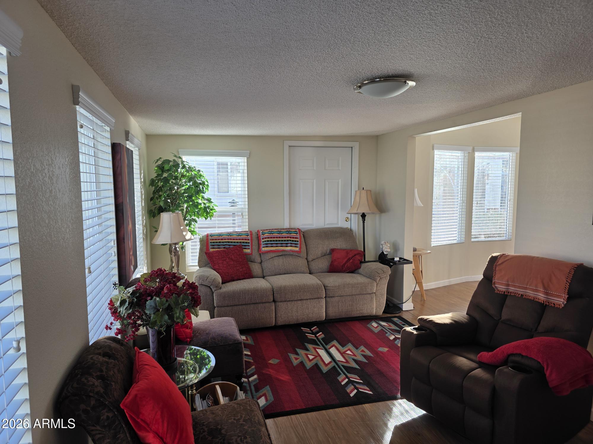 17200 West Bell Road, Unit 2169 Surprise, AZ 85374 - Photo 12 of 25 a living room with furniture cabinets and a window
