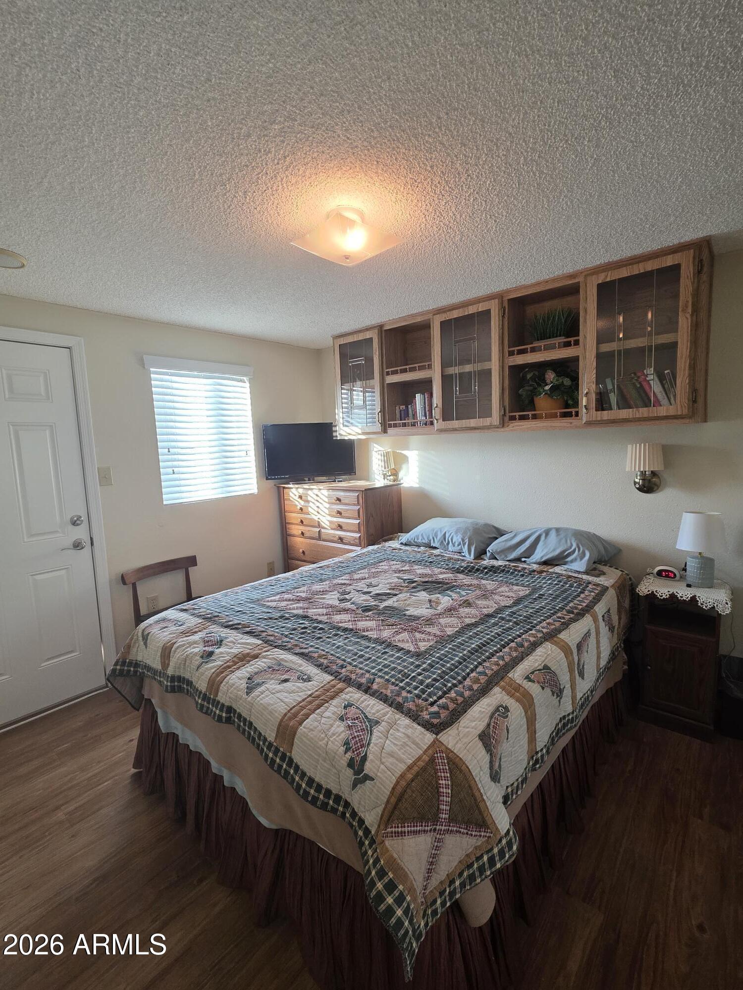 17200 West Bell Road, Unit 2169 Surprise, AZ 85374 - Photo 14 of 25 a bedroom with a bed and a large window