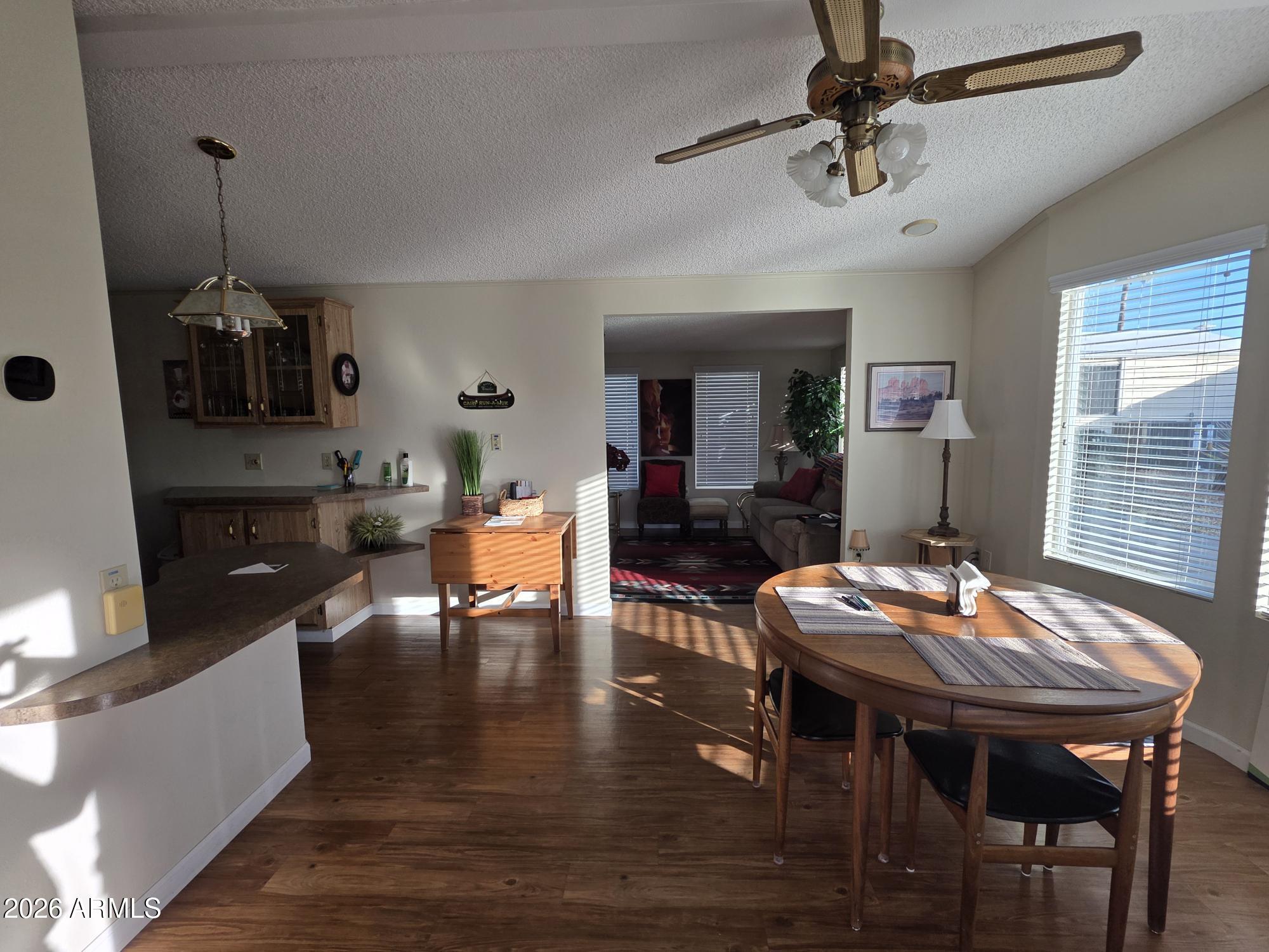 17200 West Bell Road, Unit 2169 Surprise, AZ 85374 - Photo 2 of 25 a living room with dining room and kitchen view