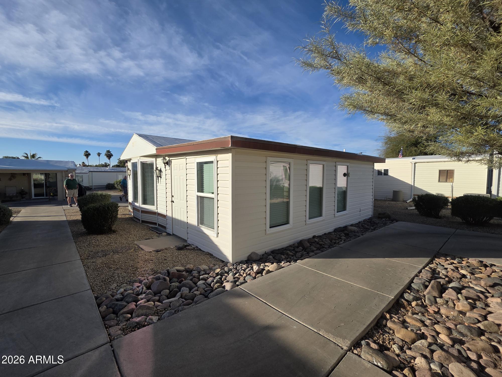 17200 West Bell Road, Unit 2169 Surprise, AZ 85374 - Photo 23 of 25 a front view of a house with a yard