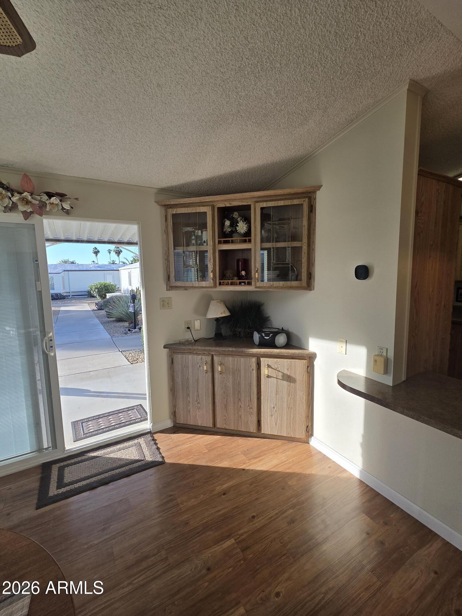 17200 West Bell Road, Unit 2169 Surprise, AZ 85374 - Photo 3 of 25 a kitchen with stainless steel appliances kitchen island granite countertop a refrigerator and a stove top oven