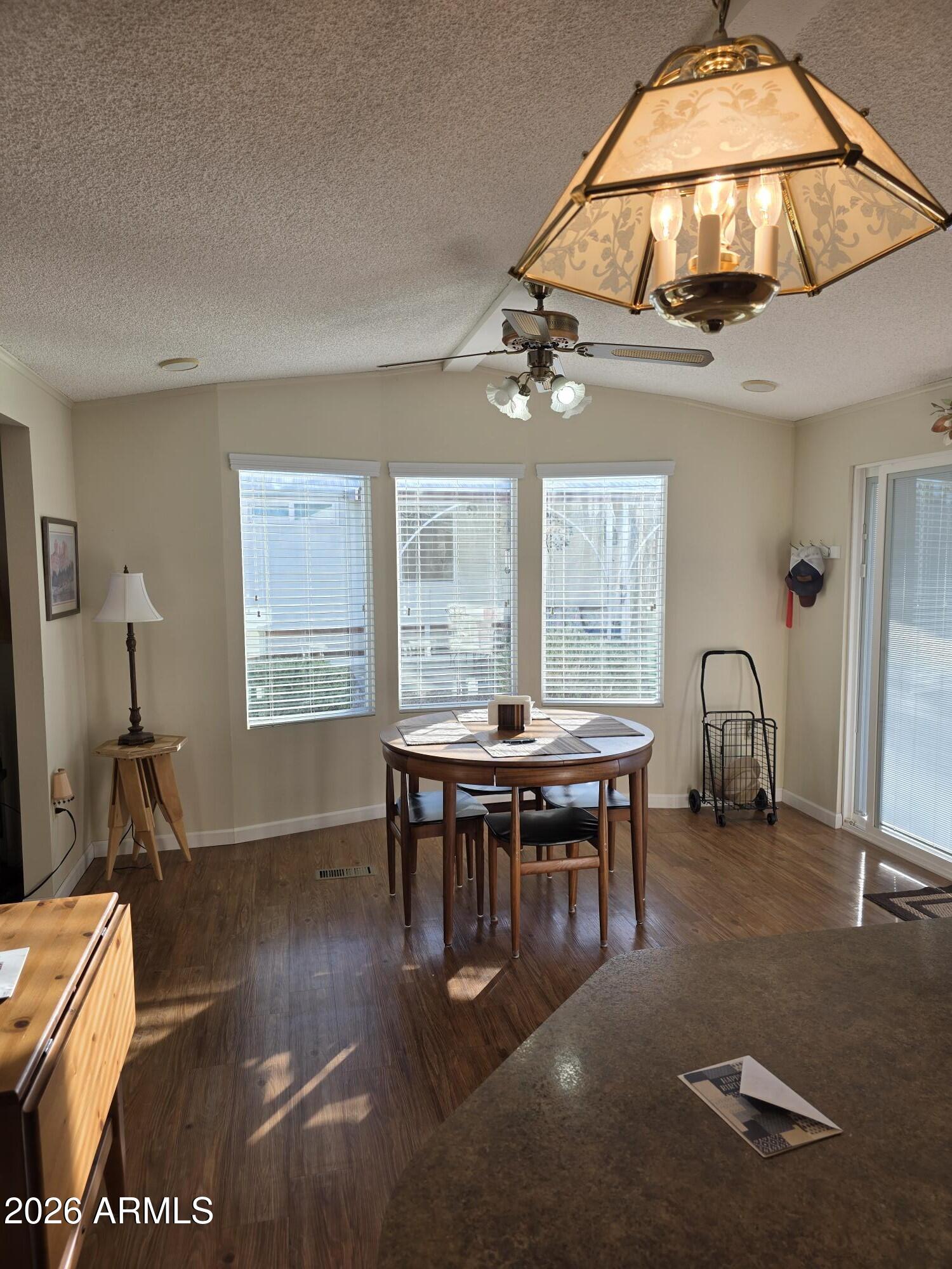 17200 West Bell Road, Unit 2169 Surprise, AZ 85374 - Photo 4 of 25 a view of a dining room with furniture window and wooden floor