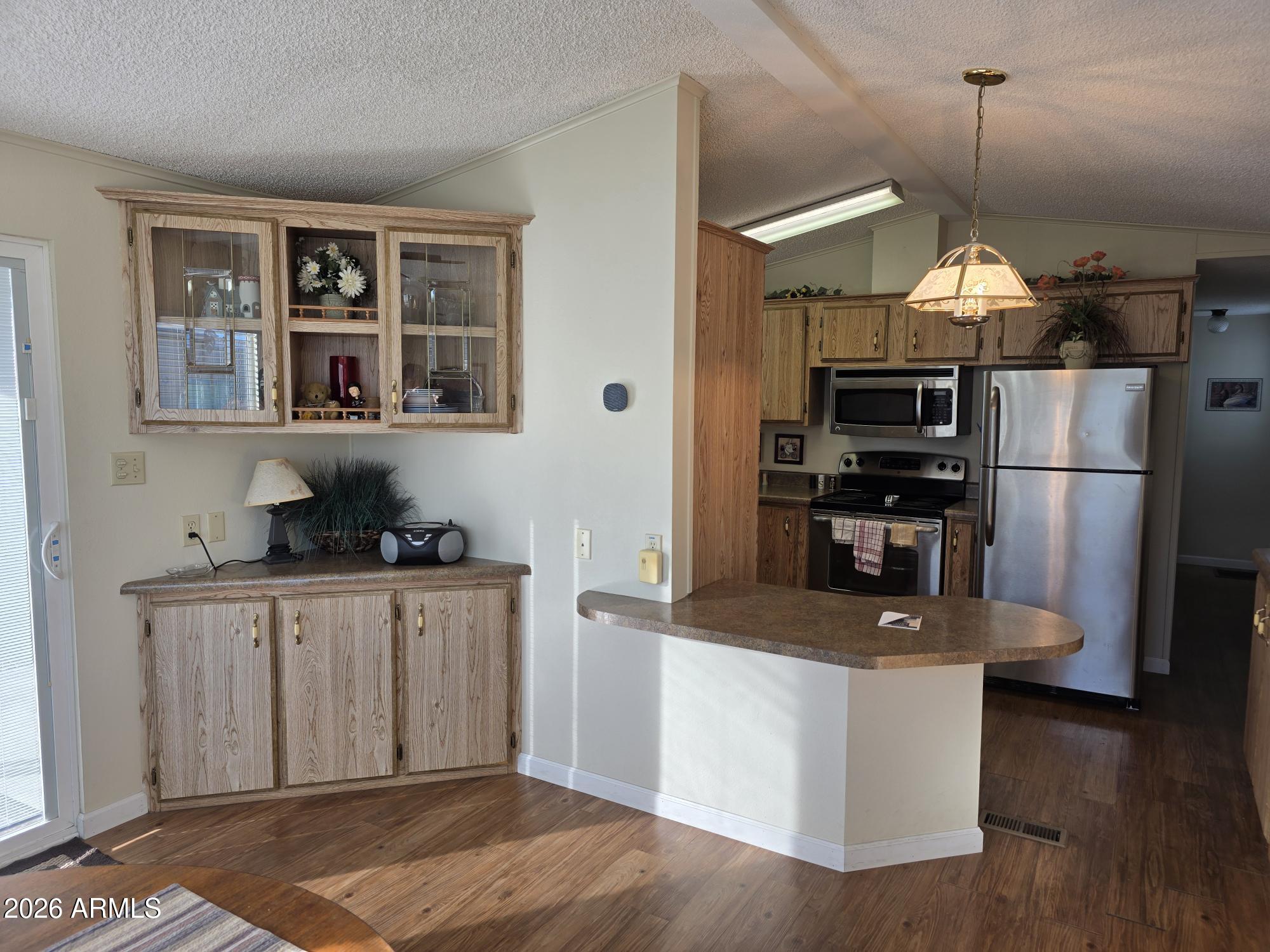 17200 West Bell Road, Unit 2169 Surprise, AZ 85374 - Photo 5 of 25 a kitchen with stainless steel appliances granite countertop a refrigerator a stove and a sink