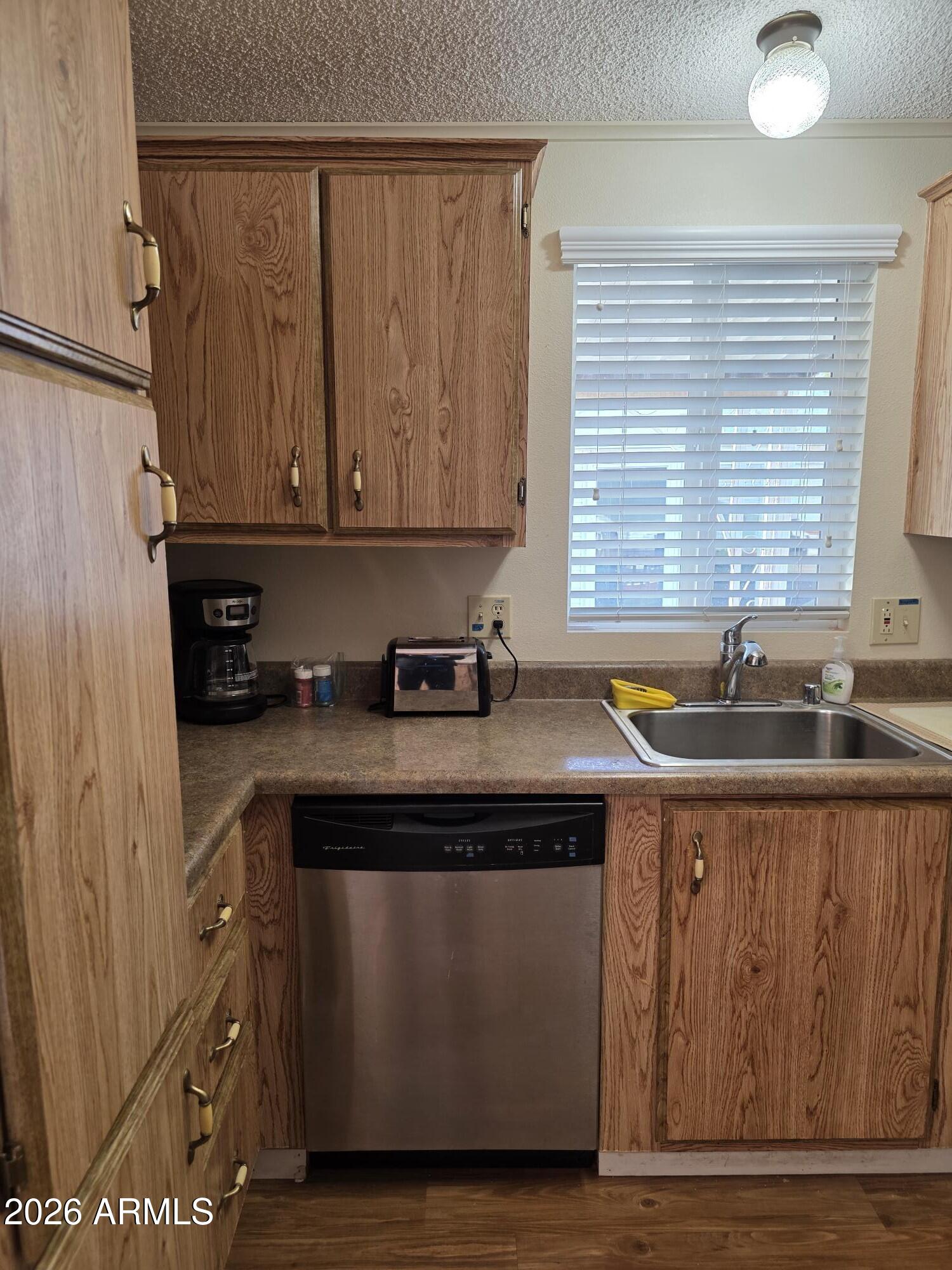 17200 West Bell Road, Unit 2169 Surprise, AZ 85374 - Photo 9 of 25 a kitchen with granite countertop a sink and a stove