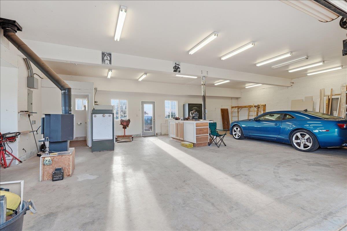 5525 Green Valley Road Placerville, CA 95667 - Photo 38 of 53 4 car garage workshop with half bath and wood-burning stove