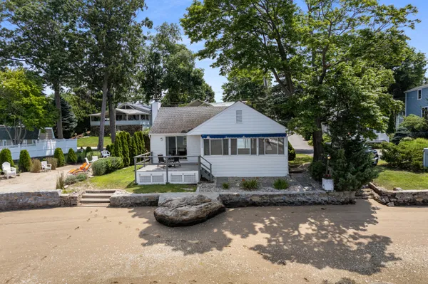 a view of a house with backyard sitting area and swimming pool