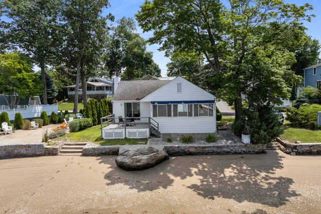 a view of a house with backyard sitting area and swimming pool