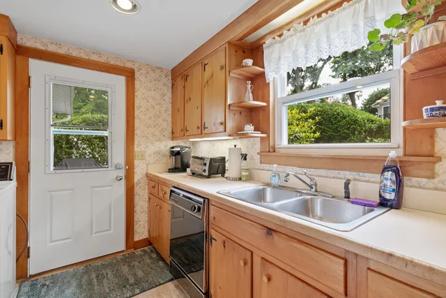 a kitchen with stainless steel appliances a stove sink and cabinets