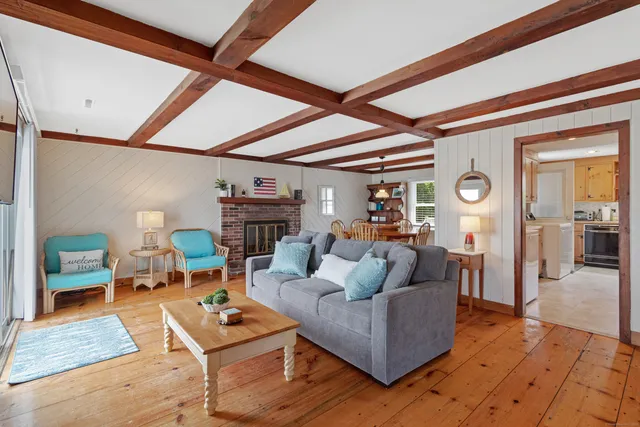 a living room with furniture and floor to ceiling windows