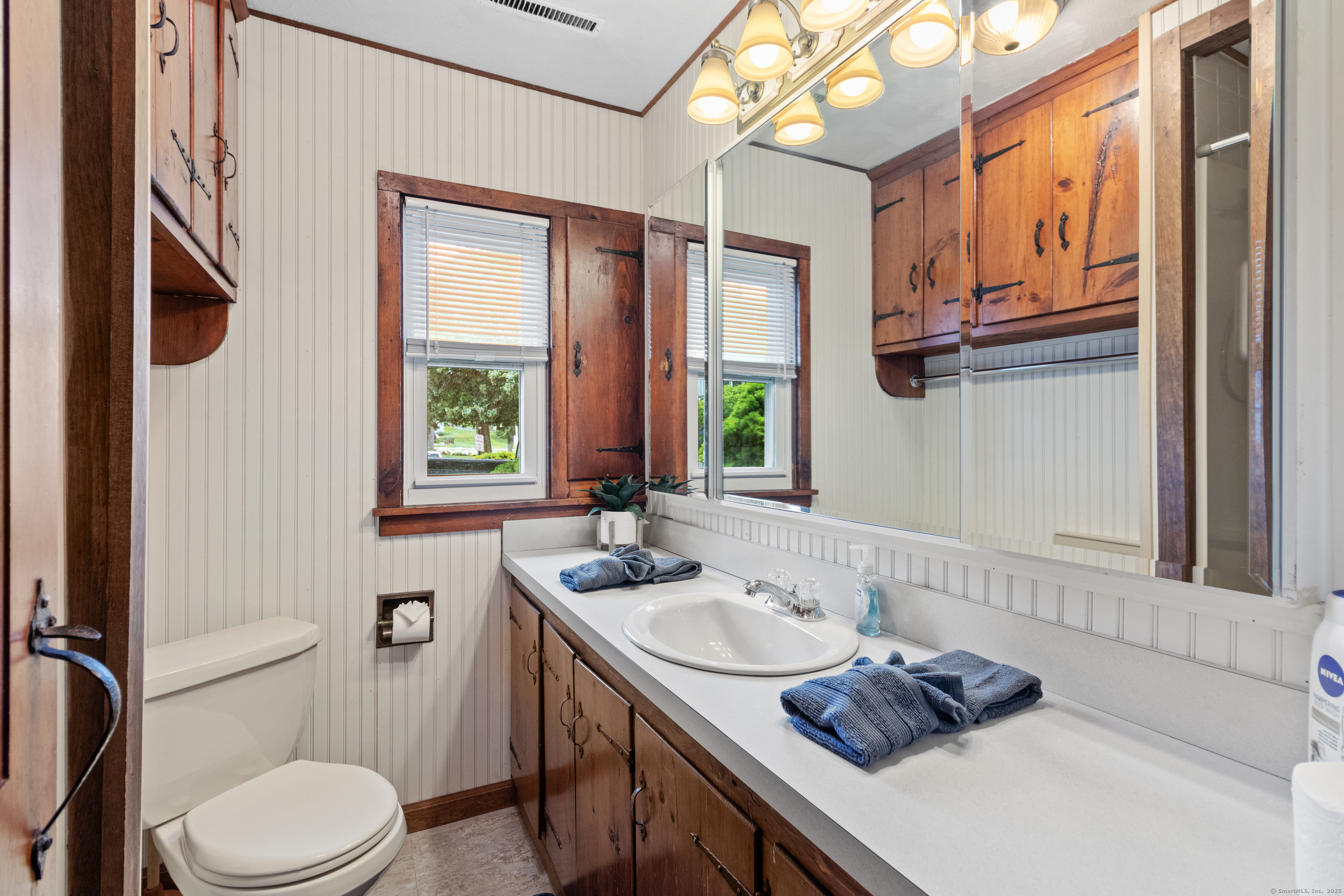 15 River Road Branford, CT 06405 - Photo 24 of 32 a bathroom with a sink a toilet and mirror