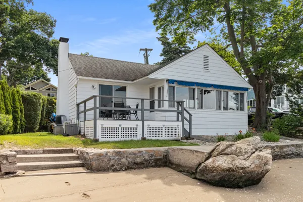 a view of a house with backyard and sitting area
