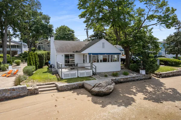 a view of a house with backyard sitting area and garden