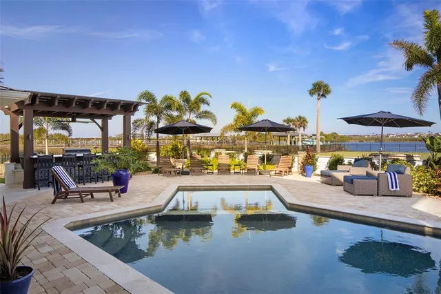 a view of a patio with table and chairs potted plants with wooden floor