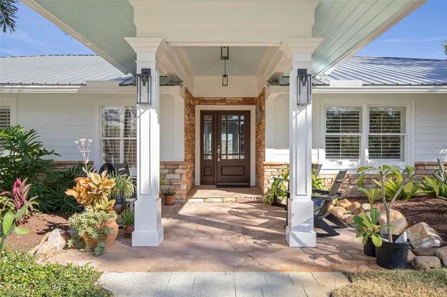 a view of a balcony with wooden floor & fence