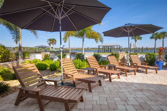 a kitchen with stainless steel appliances kitchen island granite countertop a stove a sink and a refrigerator