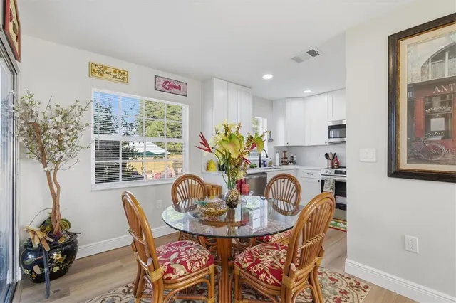 a view of a dining room with furniture and chandelier
