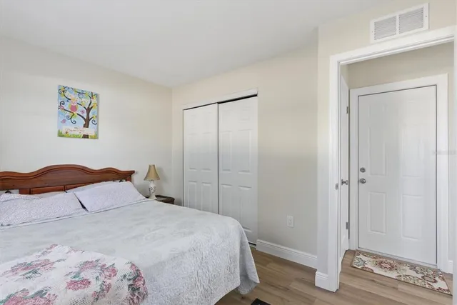a bedroom with a bed and painting on the wall