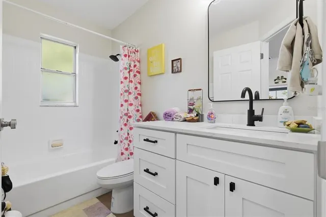 a bathroom with a sink mirror vanity and toilet