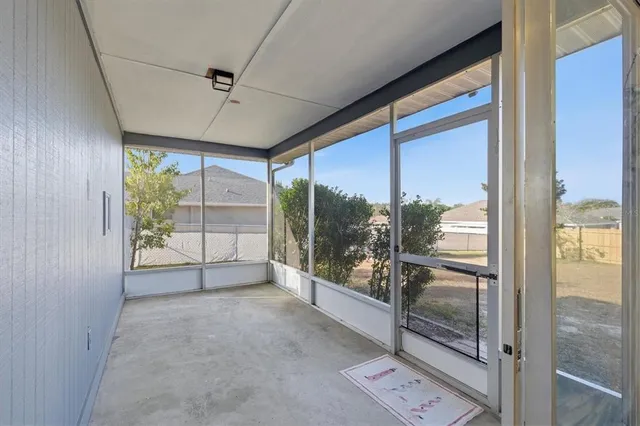 a view of a room with wooden floor and windows